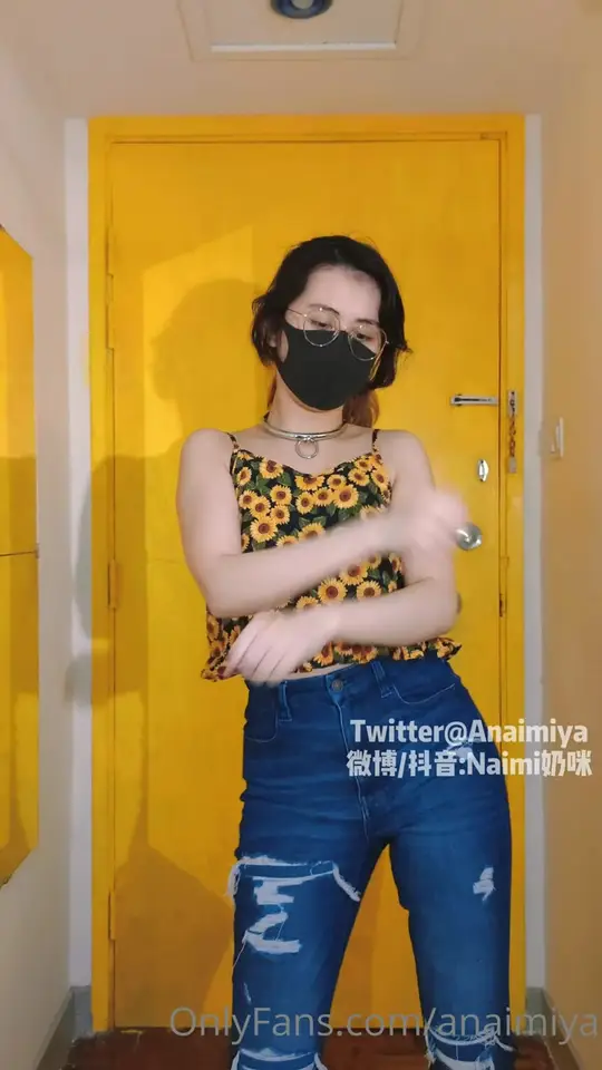 Masked brunette dances then strips slowly