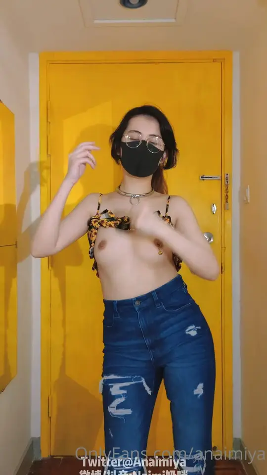 Masked brunette dances then strips slowly