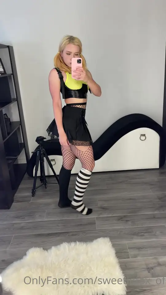 Blonde e-girl poses and lifts her skirt